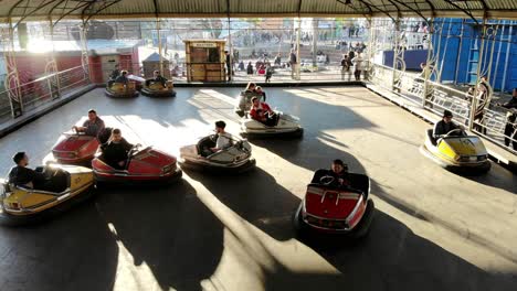 children-and-teenagers-playing-in-electric-bumper-cars-in-amusement-park-on-a-sunny-day-in-montevideo-uruguay-4K-video