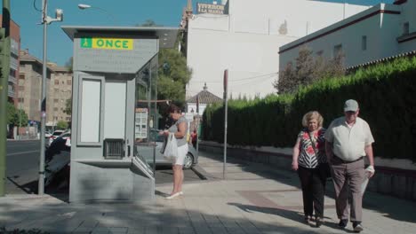 Woman-buying-fundraising-lottery-ticket-from-ONCE-kiosk-in-Spain