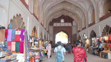 Traditional-historical-handicraft-market-Chatta-chowk-at-Red-Fort-New-Delhi-India-tourists-walking-in-panning-shot