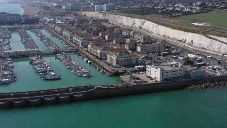 Aerial-view-of-Brighton-Marina,-moored-boats,-the-strand---apartments-on-the-Southern-coast-of-the-UK