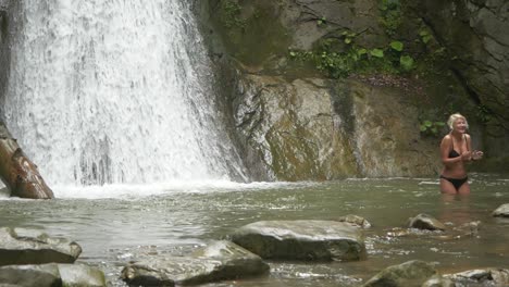 Slow-Motion-of-Young-Woman-in-Black-Bikini-Enjoying-Bath-at-Pruncea-Waterfall,-Romania