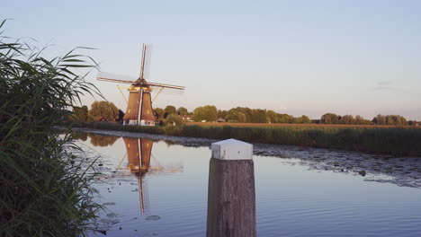 Old-Dutch-windmill-during-sunset,-wide-shot