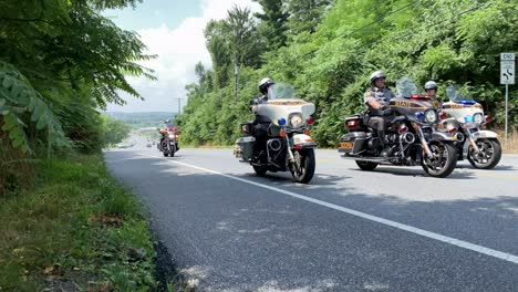 Pennsylvania-State-Police-escort,-law-enforcement-officials,-cops-on-motorcycles-with-lights-and-sirens,-public-safety-emergency-responders-in-action