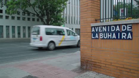 Cars-driving-by-Avenida-de-La-Buhaira-tile-lettering-in-Seville,-Spain