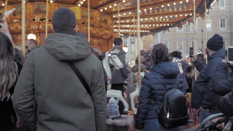 People-gather-around-a-carousel-where-children-enjoy-the-attraction