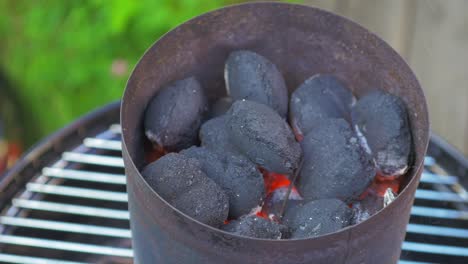 Hot-glowing-coals-laying-on-top-of-each-other-in-a-metal-container