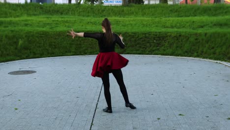 Full-body-from-the-back-view-at-female-dancer-dancing-in-the-park