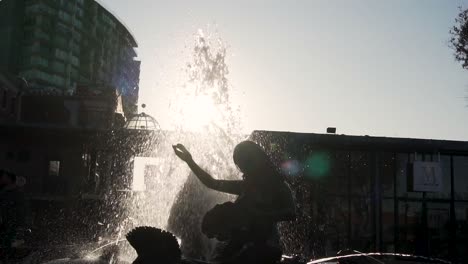 Slow-Motion-of-Fountain-Silhouette-and-Water-Spraying-With-Evening-Sun-Backlight-,-San-Francisco,-California-USA
