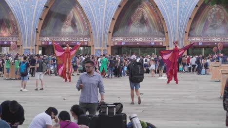 Stilt-Walkers-Performing-Around-The-People-Waiting-At-The-Entertainment-Gates-In-Tomorrowland-Held-In-Boom,-Belgium