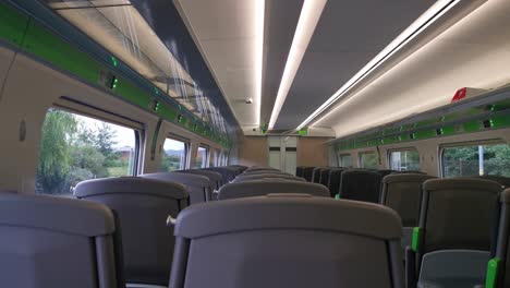 A-view-of-an-empty-UK-train-travelling-with-a-view-from-within-a-train-carriage