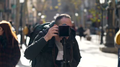 Guy-Behind-Camera-on-Pedestrian-Street,-Slow-Motion