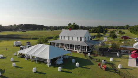 Wedding-dining-marquee-set-up-for-guests-farmhouse-countryside-orbiting-aerial