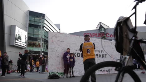 Fans-Take-Photos-at-Kobe-Bryant-Staples-Center-Memorial,-Slow-Motion-Low-Angle-Shot