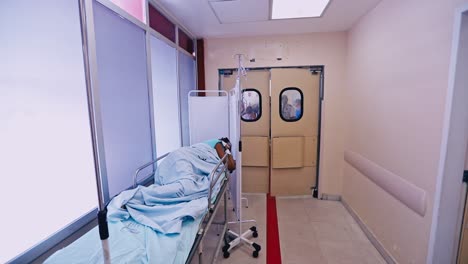 Patient-on-a-gurney-in-a-hospital-corridor-awaits-treatment