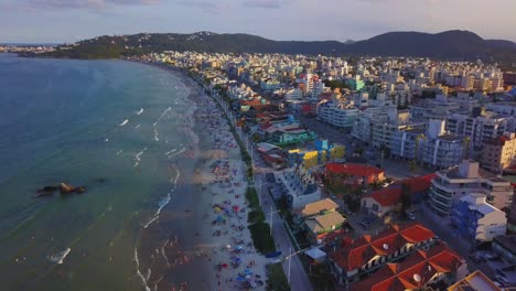Aerial-tilt-reveal-shot-of-Bombas-beach,-a-popular-beach-destination-on-the-south-of-Brazil