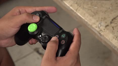 A-gamer-pressing-buttons-on-a-gamepad-controller