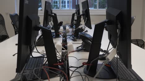 Looking-Down-Behind-Computer-Monitors-And-Plug-Sockets-On-Desk-During-Lockdown