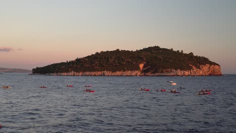 Kayakers-on-rough-waters-on-a-tour-near-Dubrovnik,-Croatia,-in-front-of-Lokrum-Island