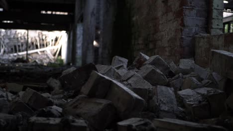 Pile-of-bricks-rubble-in-abandoned-building-panning-shot