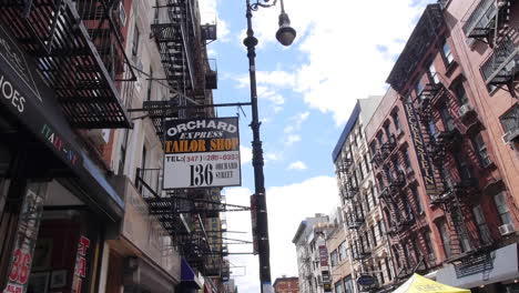 New-York-City-Tailor-Shop,-Low-Angle-Wide-Shot-–-Buildings,-Fire-Escape,-Sky