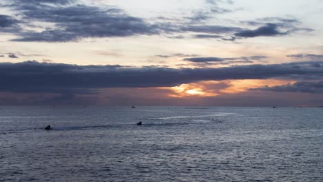 People-Jet-skiing-during-the-sunset-at-Costa-Adeje,-Tenerife