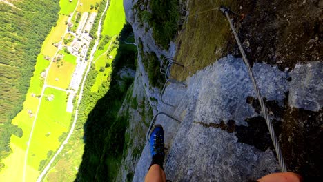 A-man-walking-down-the-metal-steps-along-the-via-ferrata-in-lauterbrunnen-in-Switzerland