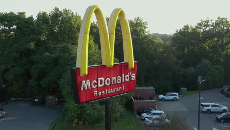 Drone-aerial-orbit-of-McDonald's-Golden-Arches-sign-branding-fast-food-restaurant-chain
