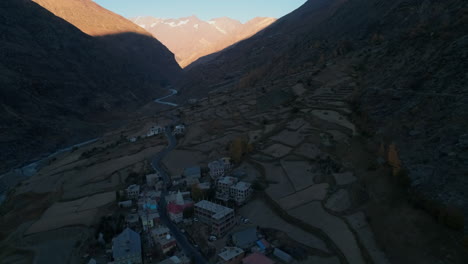 Establishing-drone-shot-of-a-peaceful-mountain-village-during-autumn-season