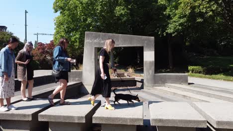 Panout-Unmasked-ladies-cross-futuristic-modern-dried-concrete-fountain-city-park-disobeying-social-distancing-laws-walking-talking-in-close-proximity-to-each-other-in-uptown-area-of-Granville-Island