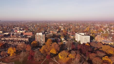 Aerial-View-Of-Buildings-And-Colorful-Trees-Near-Detroit-River-In-Wyandotte-Michigan-In-Autumn---drone-pullback
