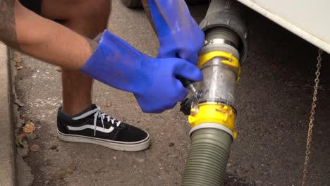 Man-washes-out-Grey-Water-drain-on-RV