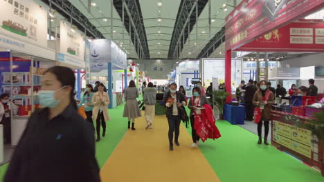 Visitors-wearing-masks-and-attending-booths-at-Health-products-exhibition-in-Guangzhou,-China-during-COVID-19-Pandemic