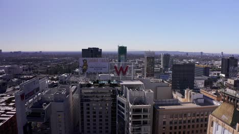 Aerial-panning-shot-of-Hollywood-with-Downtown-Los-Angeles-in-the-background