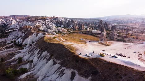 Aerial-is-flying-sideways-during-Golden-hour-in-Kizilcukur-Valley,-Göreme,-Cappadocia