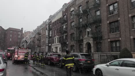 New-York-City-Firefighters-accessing-rooftop-of-building-with-ladder-truck---Wide-slow-pan-shot