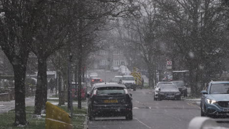 Cars-Driving-Past-On-Residential-Road-In-Snow-In-London