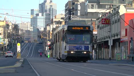 A-Yarra-Trams-driver-raises-his-mask-during-the-coronavirus-lockdown-in-Melbourne,-Australia