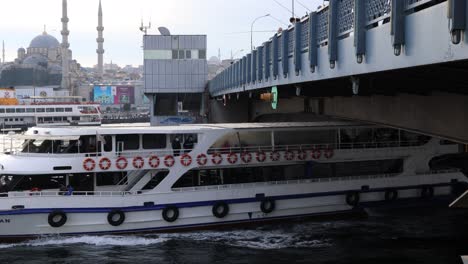 Turyol-Ferry-Boats-Sailing-In-Golden-Horn-Under-Galata-Bridge-With-Fishermen-Near-Yeni-Cami-In-Istanbul,-Turkey