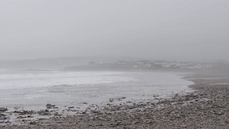 Fogged-up-beach-hit-by-waves-during-winter-storm-in-Ireland