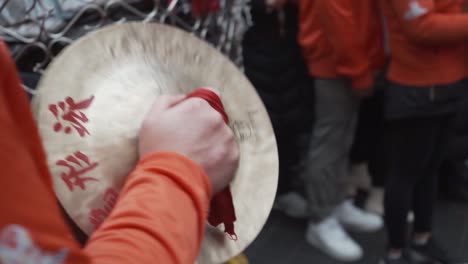 close-view-of-Chinese-man-playing-percusion-cymbals-making-music-in-london-china-town-during-new-year-celebration-england