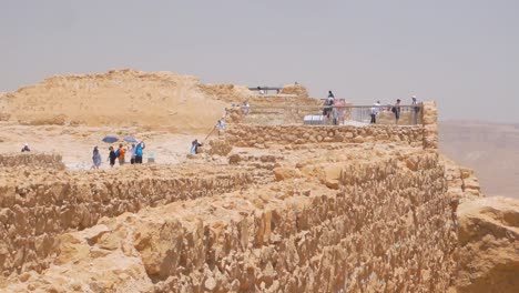 Group-of-tourists-on-Ruins-of-the-ancient-Masada-fortress-in-Israel