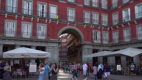 Locked-off-static-view-of-arch-at-Plaza-Mayor-main-square-in-Madrid,-Spain-at-sunset
