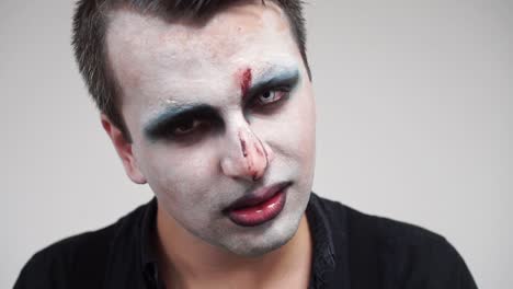 Angry-smile-of-man-with-face-paint,-slow-motion-closeup