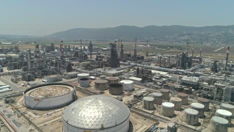 Aerial-footage-of-a-large-scale-Oil-refinery-with-smoke-stacks-and-petroleum-storage-tanks
