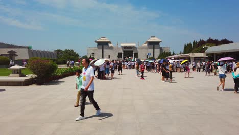 Xian,-China---July-2019-:-Tourists-walking-on-a-path-road-leading-to-a-museum-site-building-containing-Terracota-Army-sculptures,-Xian,-Shaanxi-Province