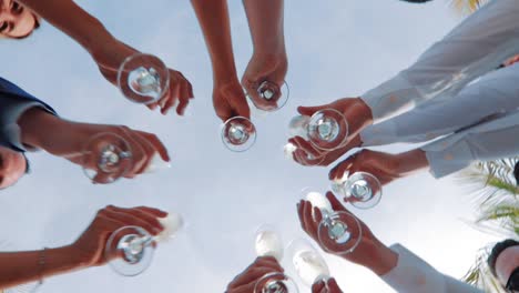 People-toasting-from-below-with-champagne-glasses-at-party