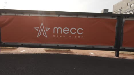 A-slow-motion,-backwards-moving-shot-of-a-red-banner-with-the-name-MECC