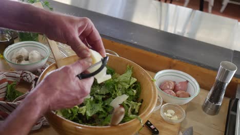 cutting-the-cheese-into-the-salad