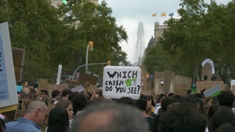 A-crowd-of-people-holding-green-environment-signs-to-protest-during-the-annual-festival-of-La-Merce