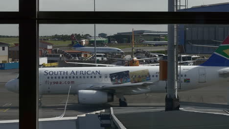 South-African-Airlines-jet-taxis-past-window-at-Johannesburg-airport